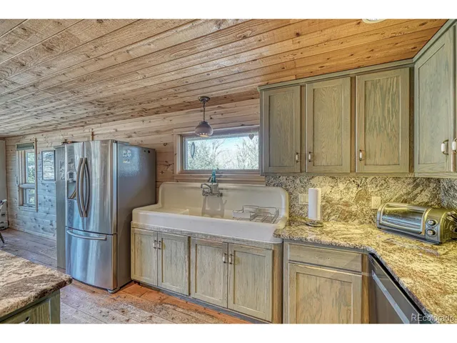 a living room with furniture a wooden floor and a sink