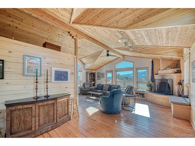 a living room with furniture a ceiling fan and a rug