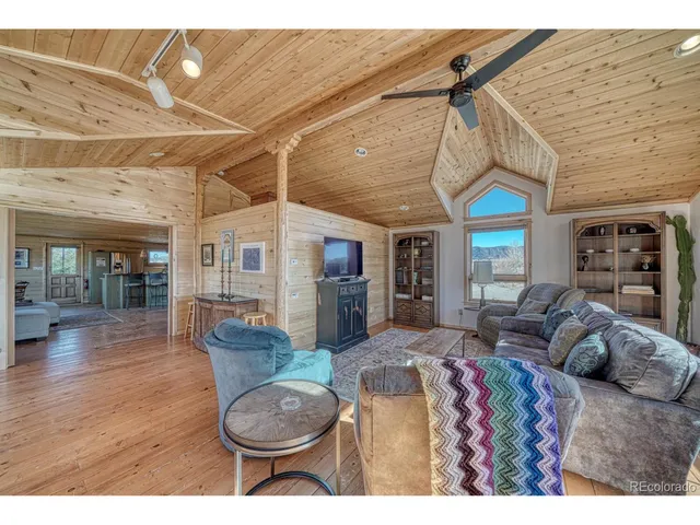 a view of a living room and kitchen with furniture and a fireplace