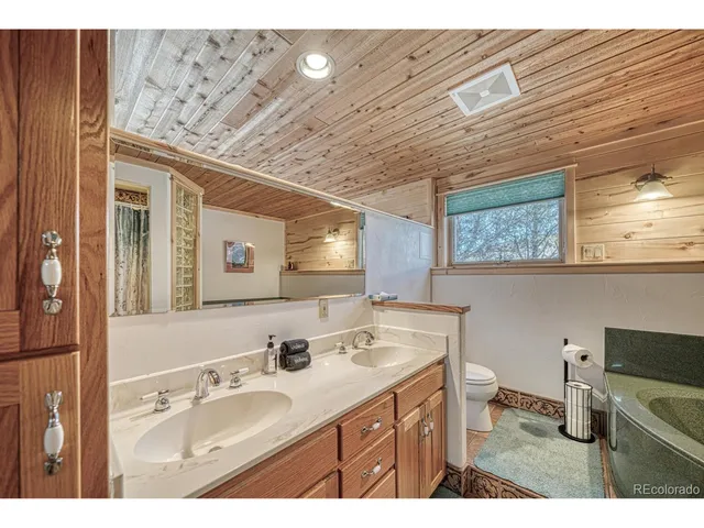 a bathroom with a sink double vanity and a mirror