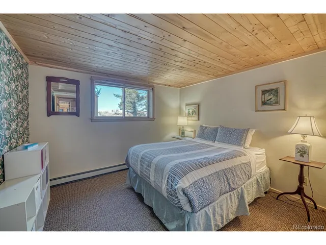a bedroom with furniture and large windows