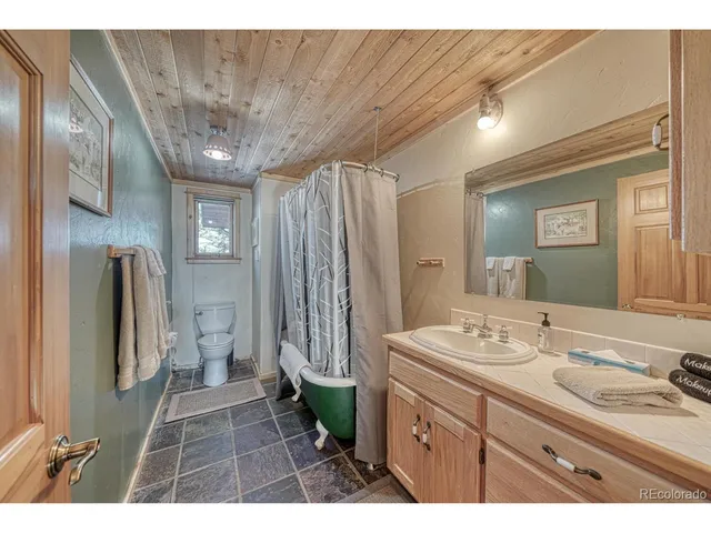 a aerial view of a house with a yard and balcony