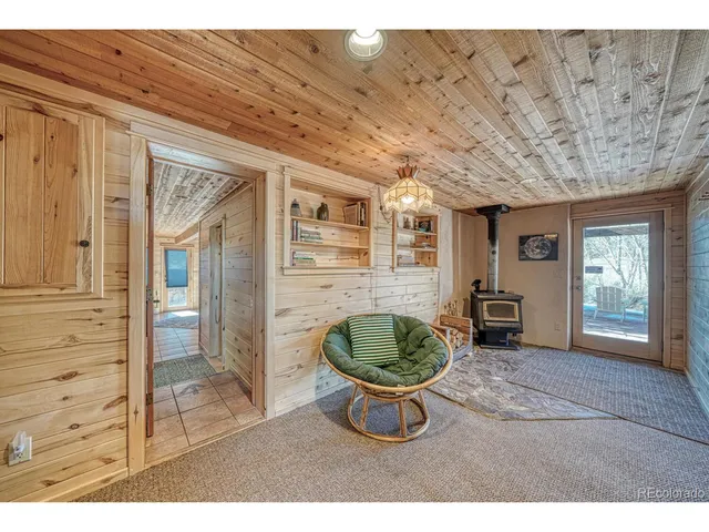 a living room with furniture and a kitchen view