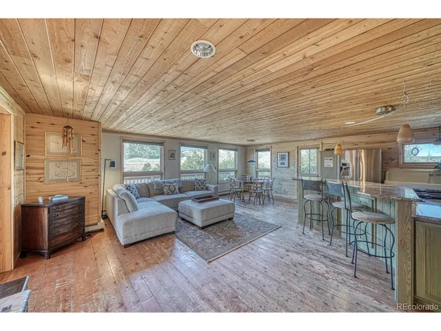 a kitchen with stainless steel appliances kitchen island granite countertop a table and chairs