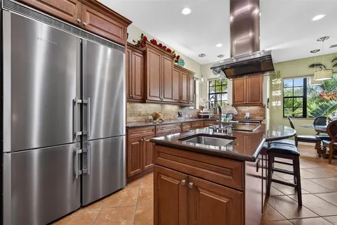 a bedroom with a bed and a flat tv screen on dresser