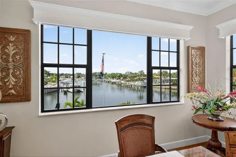 a spacious bedroom with a large bed a flat tv screen and a fireplace