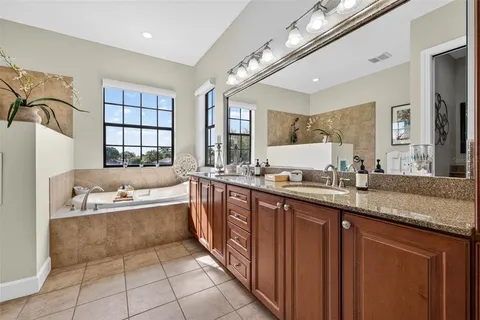 a kitchen with granite countertop wooden cabinets and a wooden floor