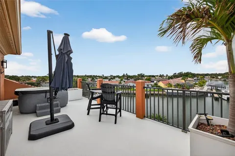 a view of a house with pool plants and large trees
