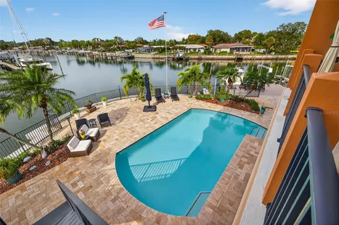 a view of a chairs and table in patio with a lake view
