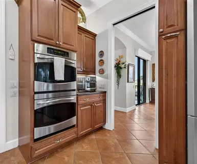 a dining room with furniture a chandelier and window