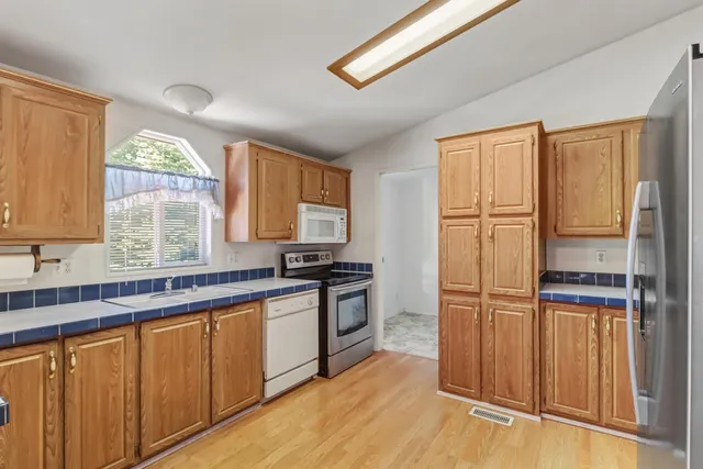a metallic refrigerator freezer sitting in a kitchen