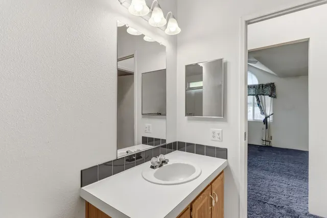 a bathroom with a shower and a sink