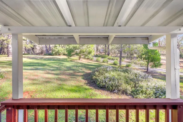 a view of a house with a yard and sitting area