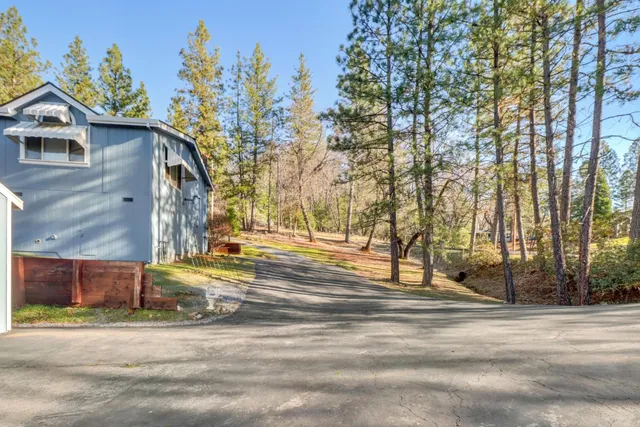 a view of a house with a yard and tree s