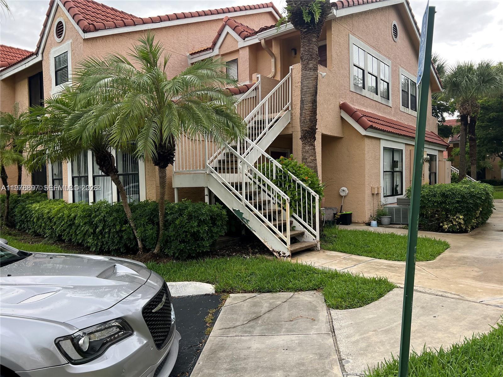 15581 Southwest 104th Terrace, Unit 224 Miami, FL 33196 - Photo 2 of 18 a front view of a house with garden