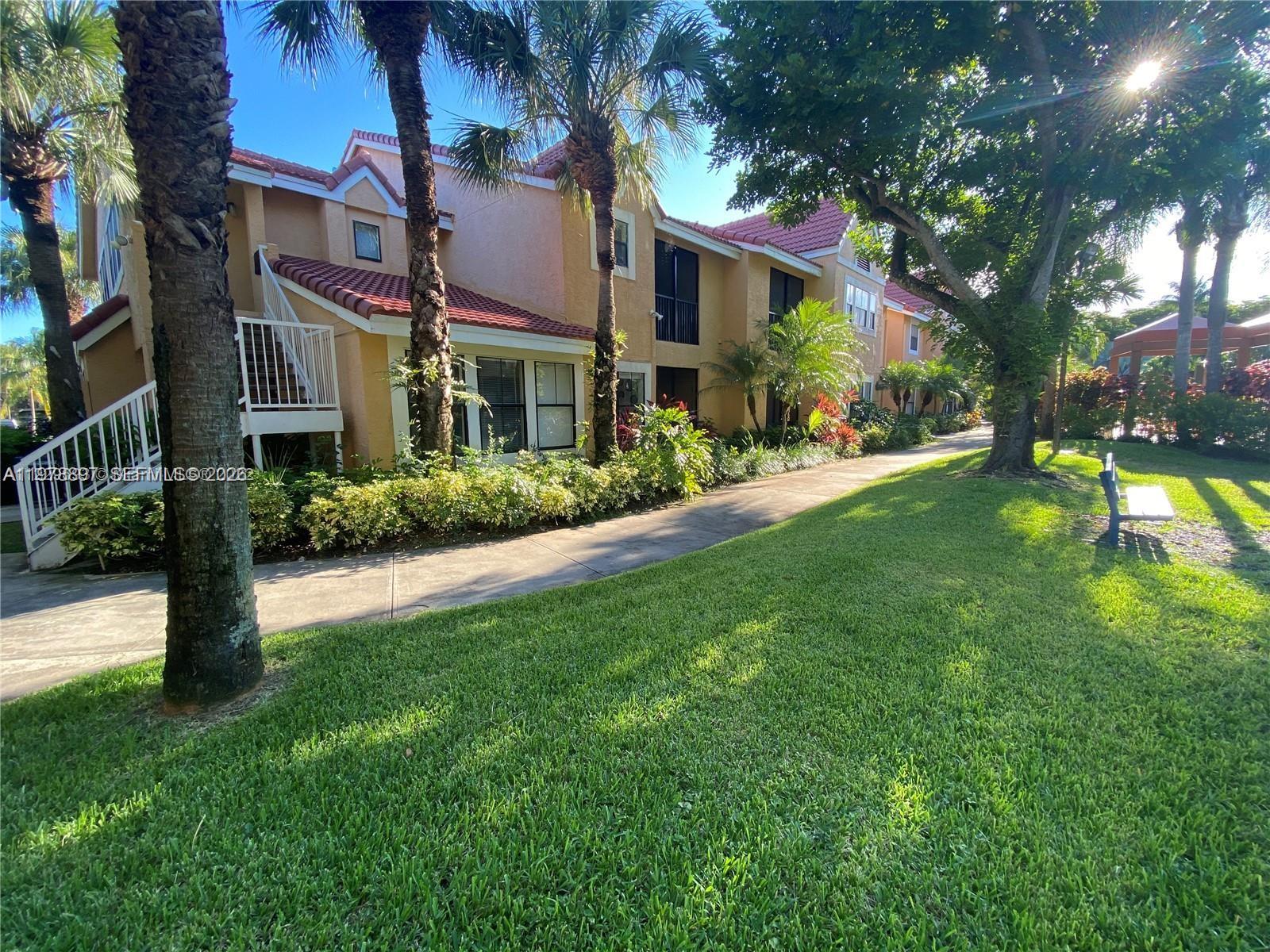 15581 Southwest 104th Terrace, Unit 224 Miami, FL 33196 - Photo 3 of 18 a view of a building with a yard