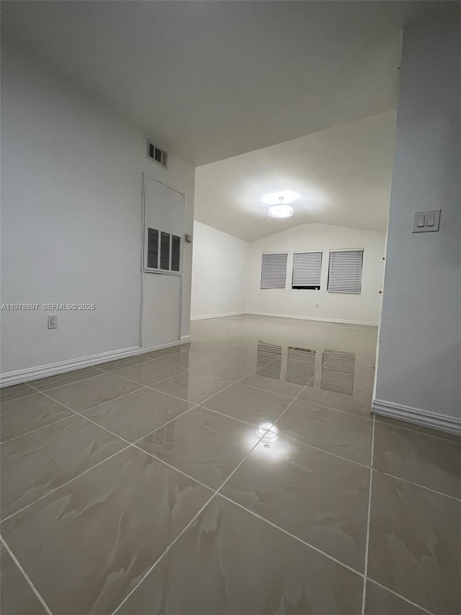 15581 Southwest 104th Terrace, Unit 224 Miami, FL 33196 - Photo 5 of 18 a view of a livingroom with wooden floor and a window