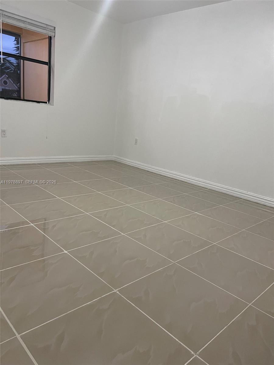 15581 Southwest 104th Terrace, Unit 224 Miami, FL 33196 - Photo 10 of 18 a bathroom with white tiles and a window
