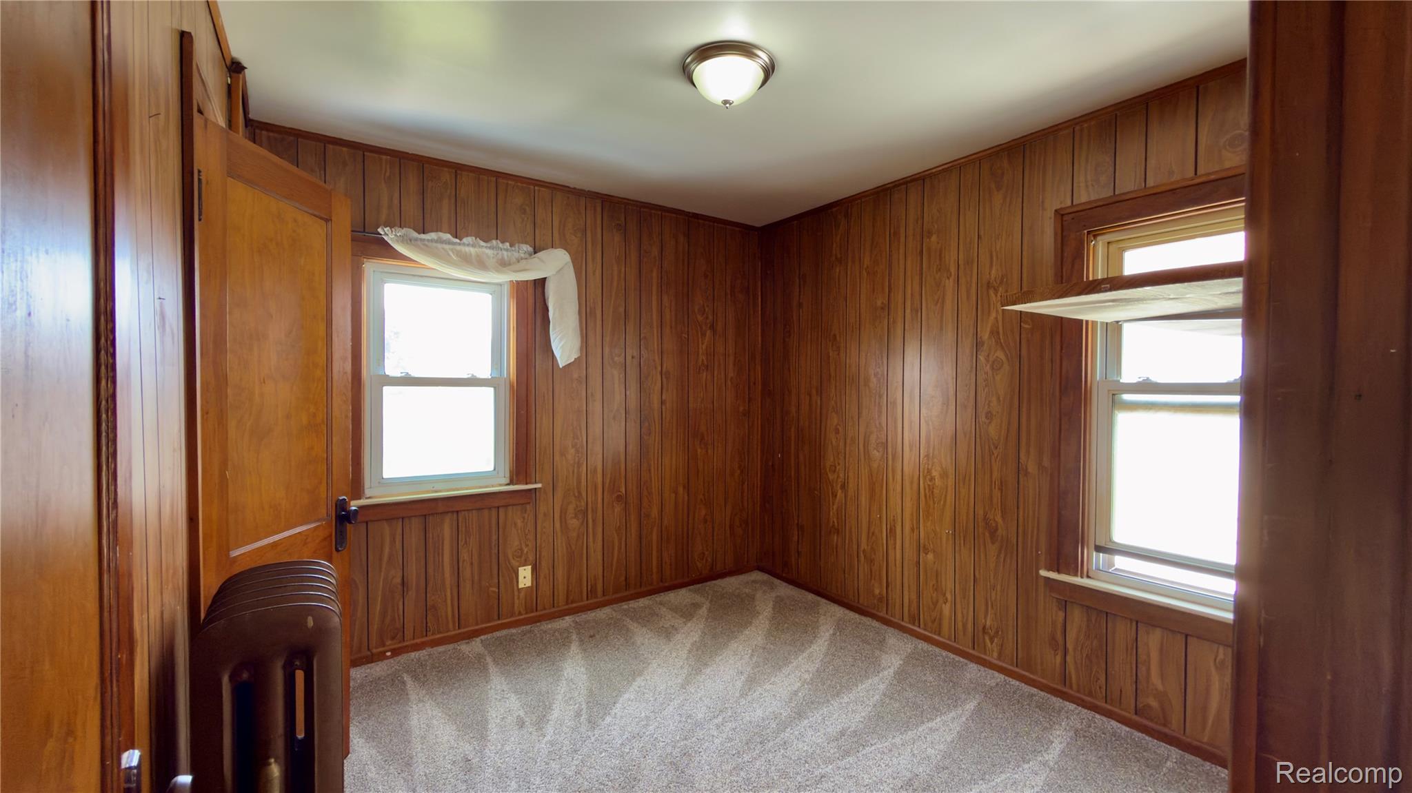 130 Elm Street River Rouge, MI 48218 - Photo 18 of 20 Interior space featuring wood-paneled walls and neutral patterned carpeting