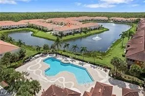 an aerial view of residential houses with outdoor space and lake view