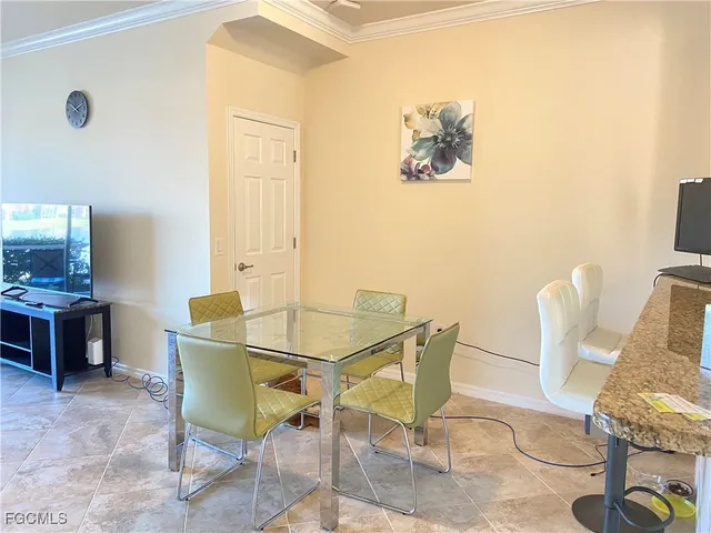 a view of a dining room with furniture and a potted plant