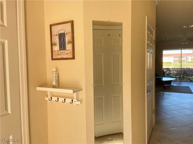 a view of a hallway with a door and wooden floor
