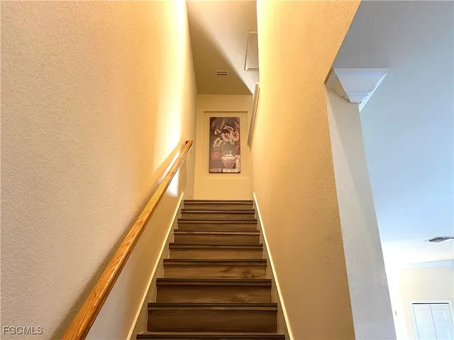 a view of a hallway with wooden floor and entryway
