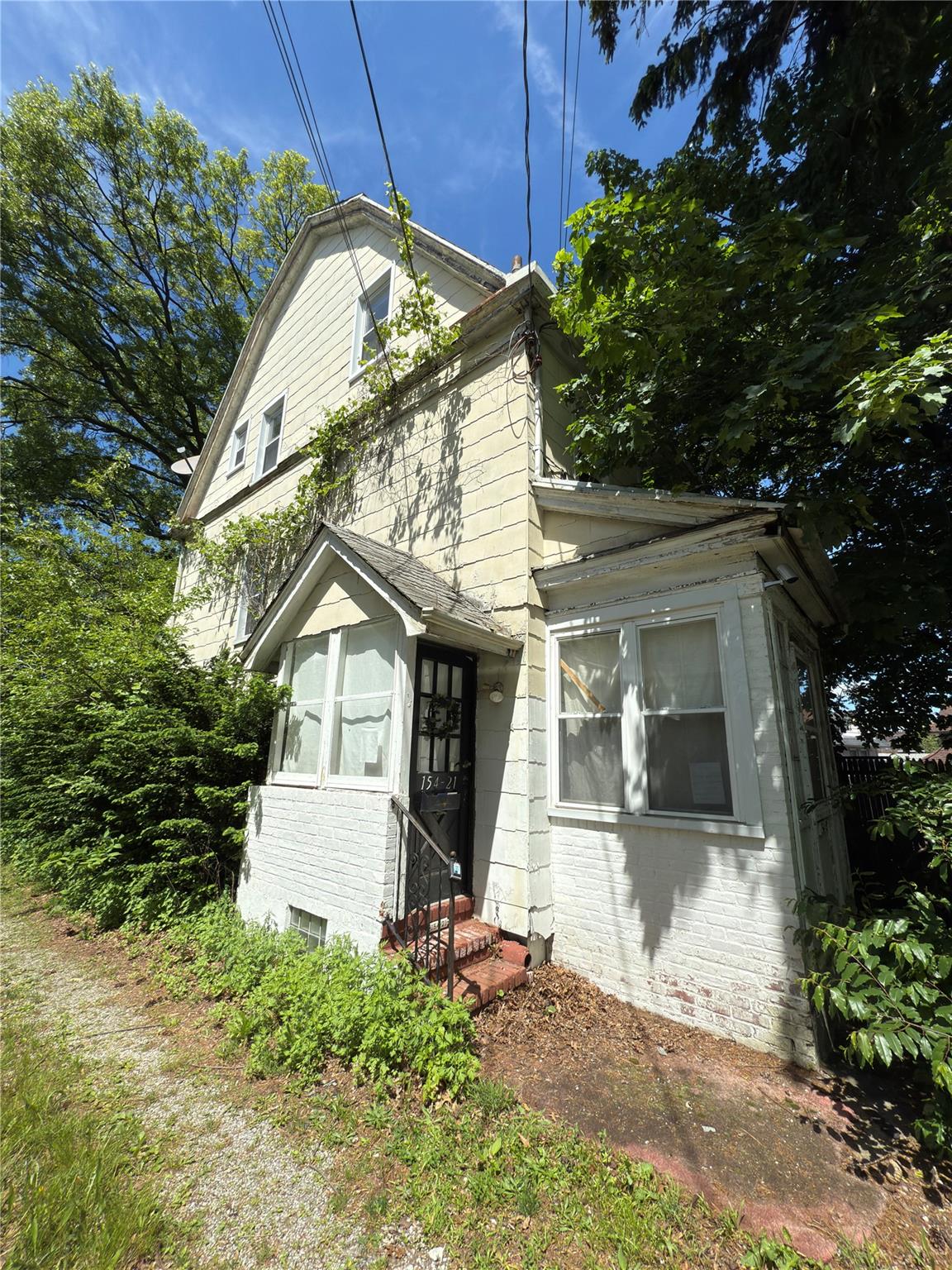154-21 Ash Avenue Queens, NY 11355 - Photo 2 of 5 a front view of a house with a yard
