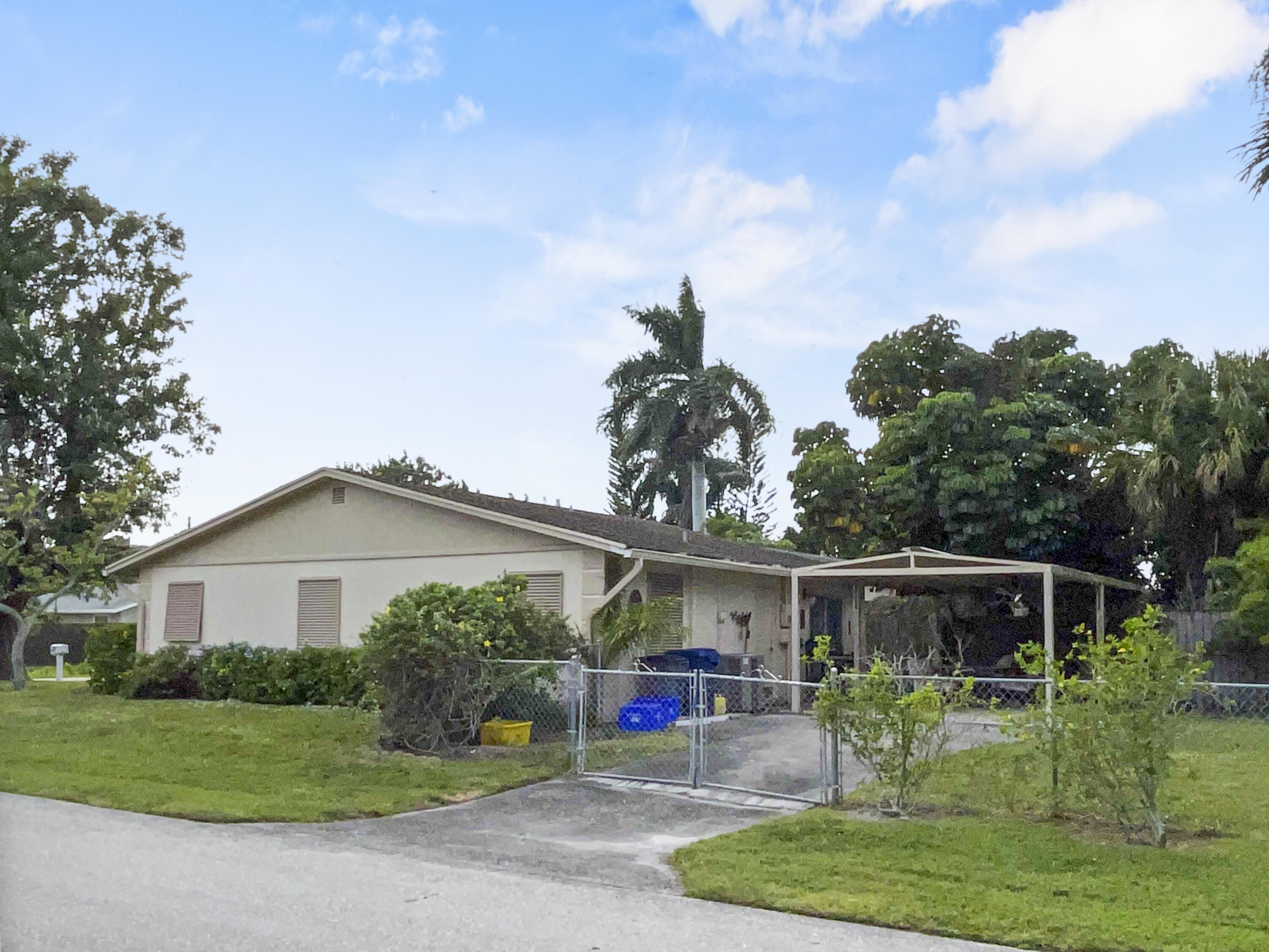 1001 Comanche Street Jupiter, FL 33458 - Photo 27 of 35 Fenced backyard with extra parking space