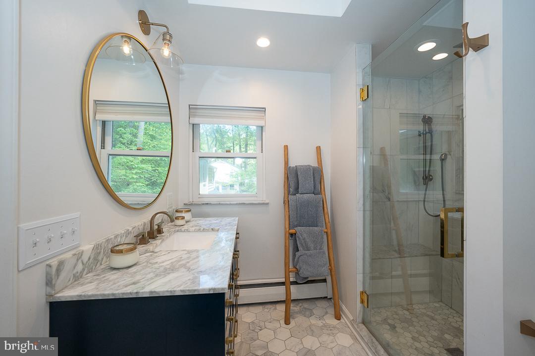 749 Mancill Road Wayne, PA 19087 - Photo 21 of 34 a bathroom with a sink a mirror and a window