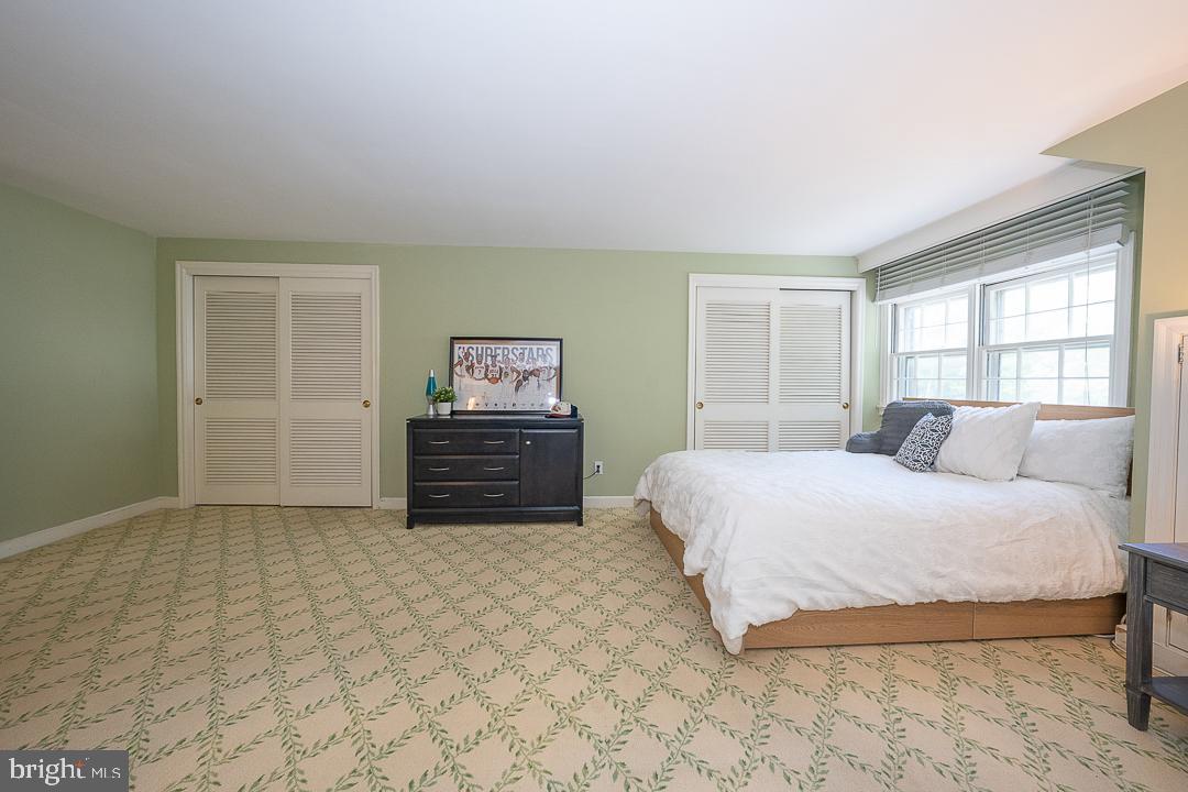 749 Mancill Road Wayne, PA 19087 - Photo 27 of 34 a spacious bedroom with a bed and a cabinets