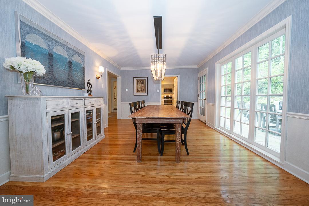 749 Mancill Road Wayne, PA 19087 - Photo 8 of 34 a dining room with furniture a chandelier and wooden floor