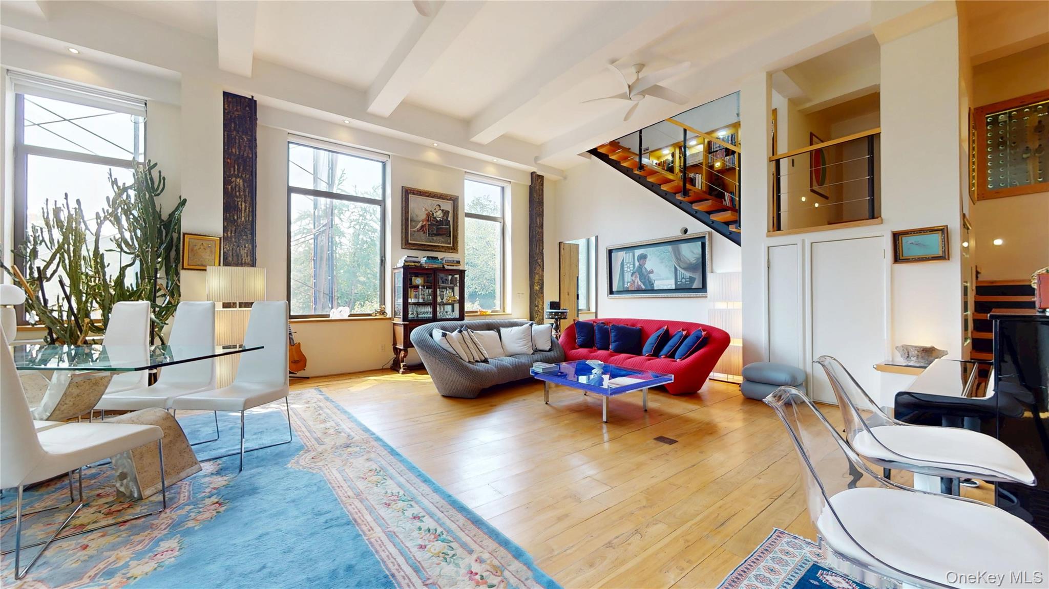 1255 5th Avenue Manhattan, NY 10029 - Photo 9 of 16 Living room featuring wood-type flooring, beamed ceiling, a ceiling fan, and stairs