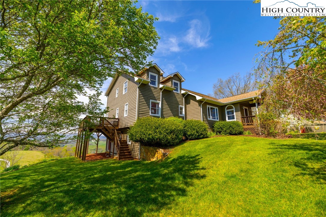 320 Buckeye Ridge Run Sparta, NC 28675 - Photo 1 of 48 a front view of a house with a garden