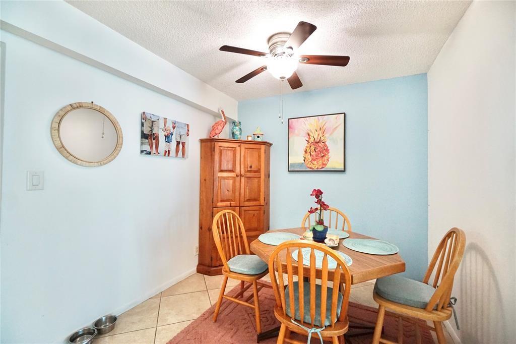 111 Briny Avenue, Unit 2307 Pompano Beach, FL 33062 - Photo 11 of 47 a view of a dining room with furniture wooden floor and a chandelier