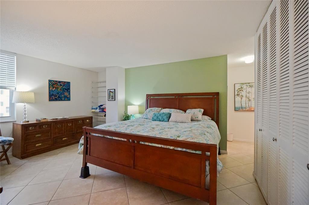 111 Briny Avenue, Unit 2307 Pompano Beach, FL 33062 - Photo 16 of 47 a bedroom with a bed and a dresser