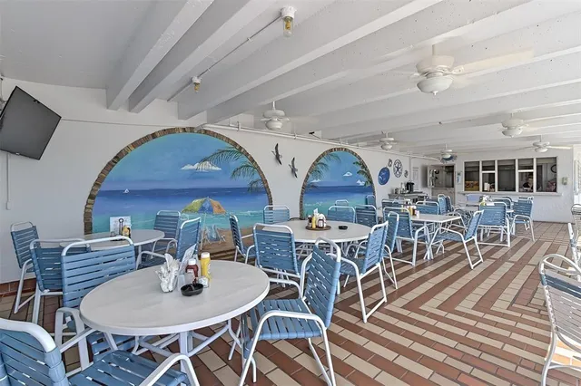 a view of a dining room with furniture chandelier and wooden floor