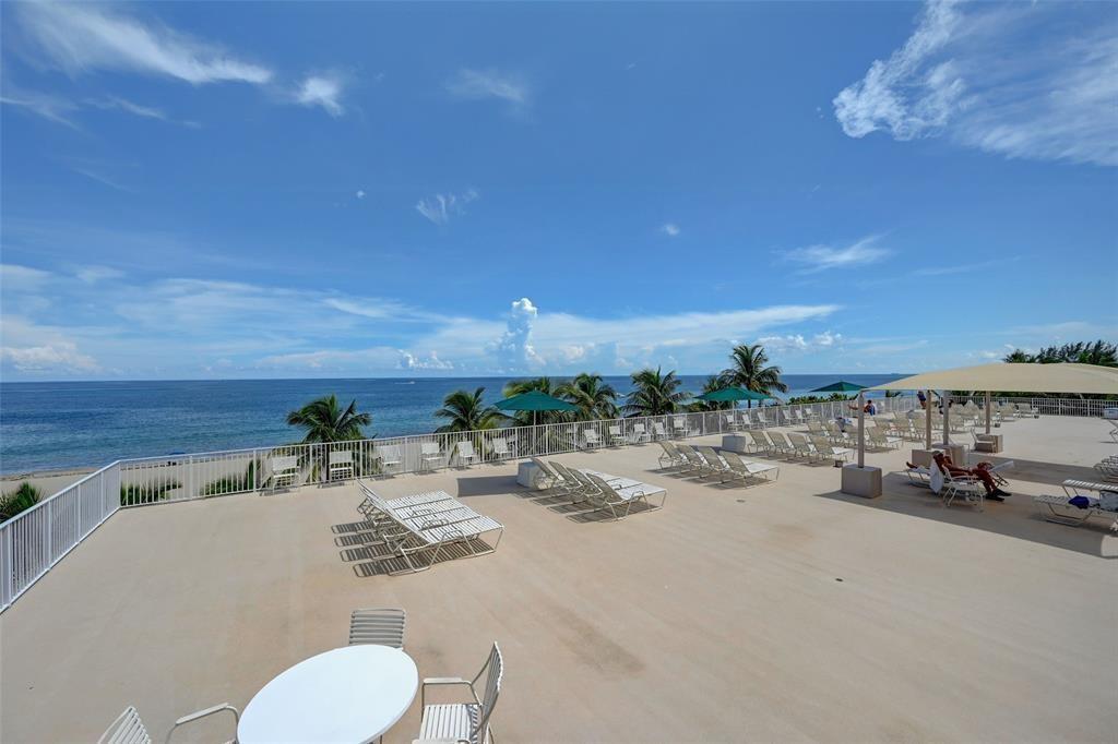 111 Briny Avenue, Unit 2307 Pompano Beach, FL 33062 - Photo 37 of 47 a view of swimming pool and outdoor seating
