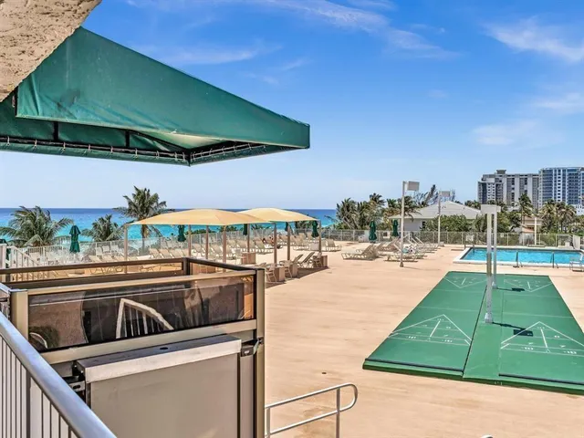 a view of swimming pool with outdoor seating and yard