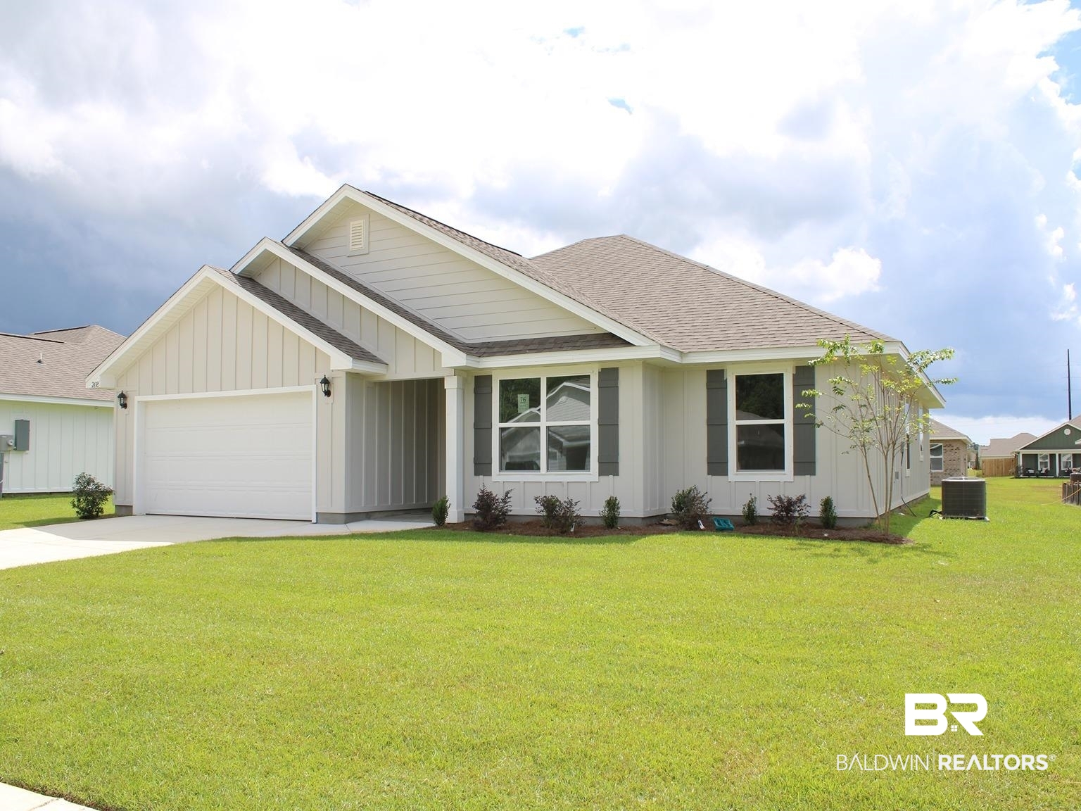 24385 Ringneck Loop Elberta, AL 36530 - Photo 3 of 33 View of front of property featuring a garage, a front lawn, and central AC