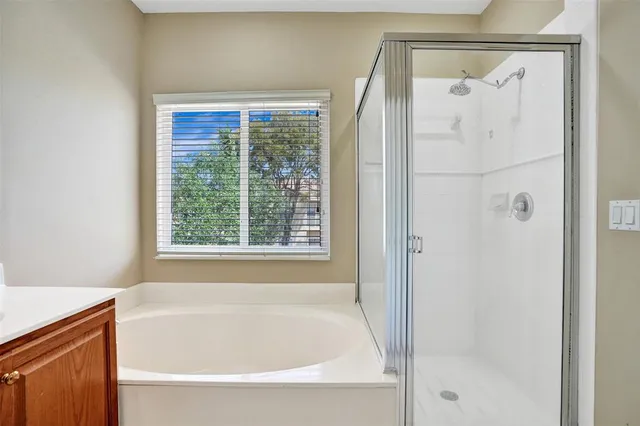 a bathroom with a bathtub and a shower