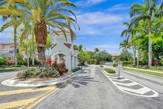 a front view of a house with a yard and fountain