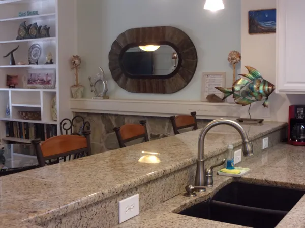 a kitchen with a sink and a stove with white walls
