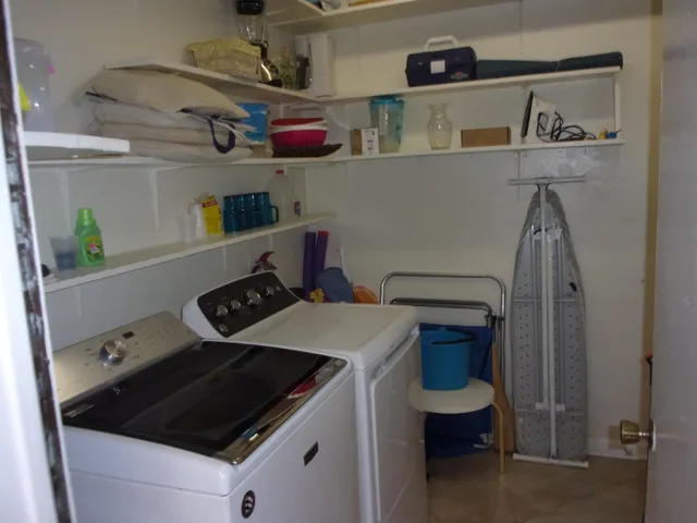 a kitchen with a refrigerator and a sink