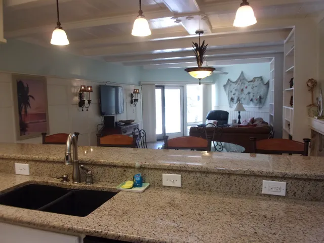 a kitchen with granite countertop a sink and a stove