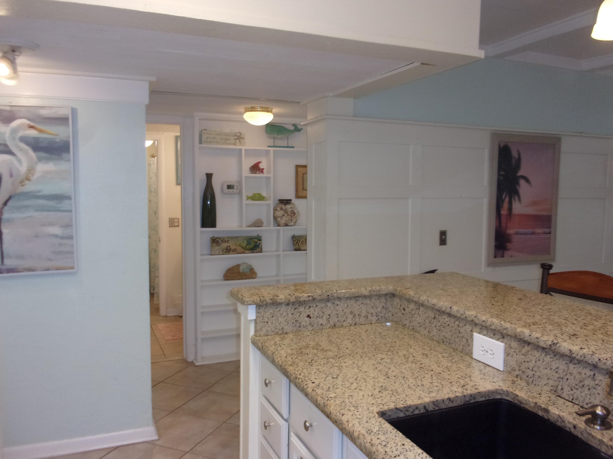 5650 A1A South, Unit B107 St. Augustine, FL 32080 - Photo 18 of 50 a kitchen with granite countertop a sink and a stove