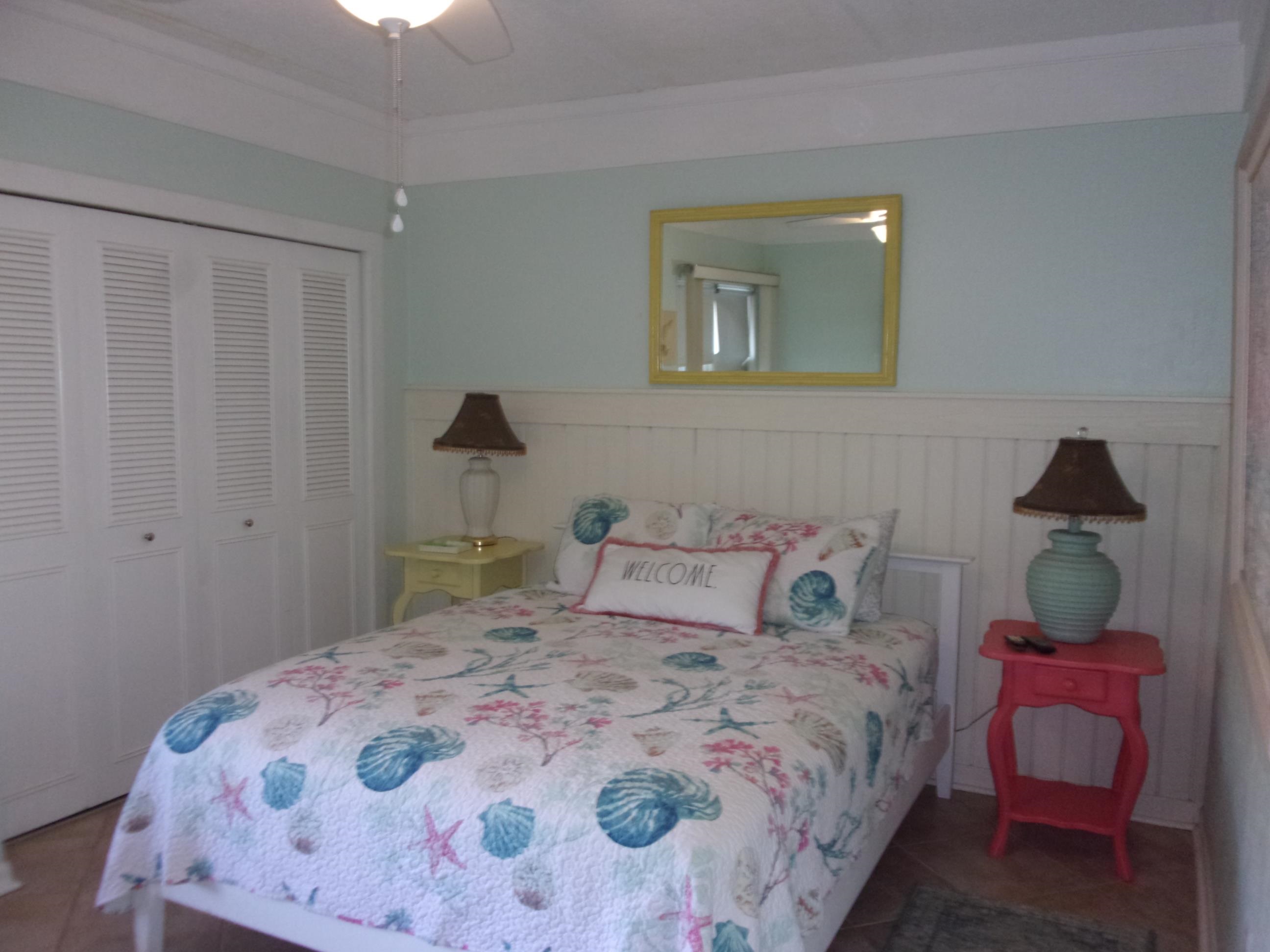 5650 A1A South, Unit B107 St. Augustine, FL 32080 - Photo 26 of 50 a bedroom with a bed and a dresser in it