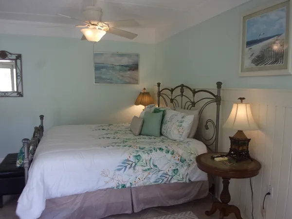 a bedroom with a bed and a television