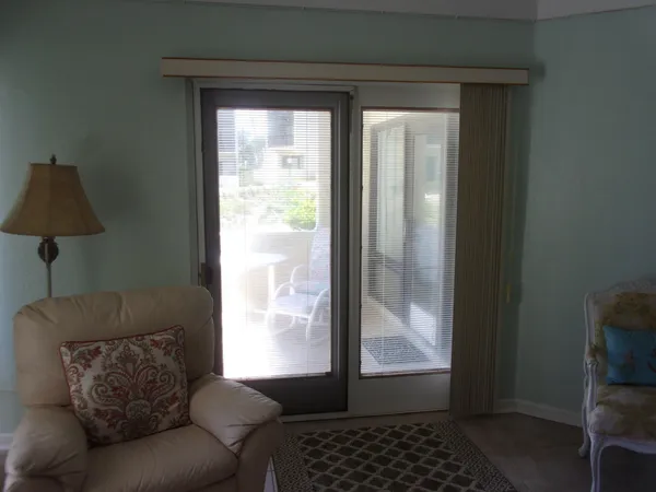 a view of a chairs and table in the balcony