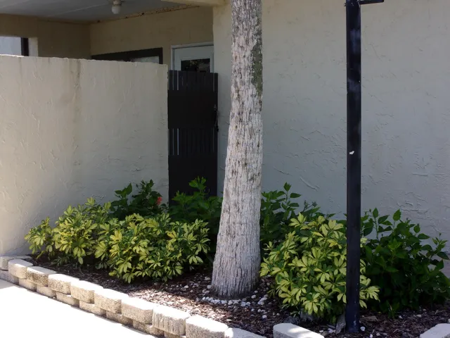 a vase with flowers sitting on a table in front of a window